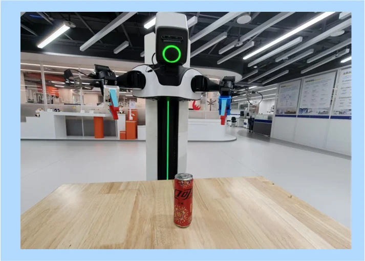 Real-world dual-arm robot setup for the MoE-ACT bottle handover task.